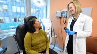 Dermatologist and patient in exam room
